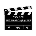 A black and white movie clapperboard graphic with a slightly open top. The center is inscribed with the motivational phrase "YOU ARE THE MAIN CHARACTER" in a white, chalk-like font. The bottom section includes the numbers 1, '80, and 6. The image has a thin white border, similar to a die-cut sticker.